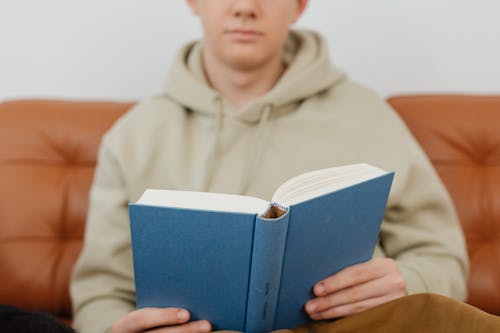 A Person Holding a Blue Book