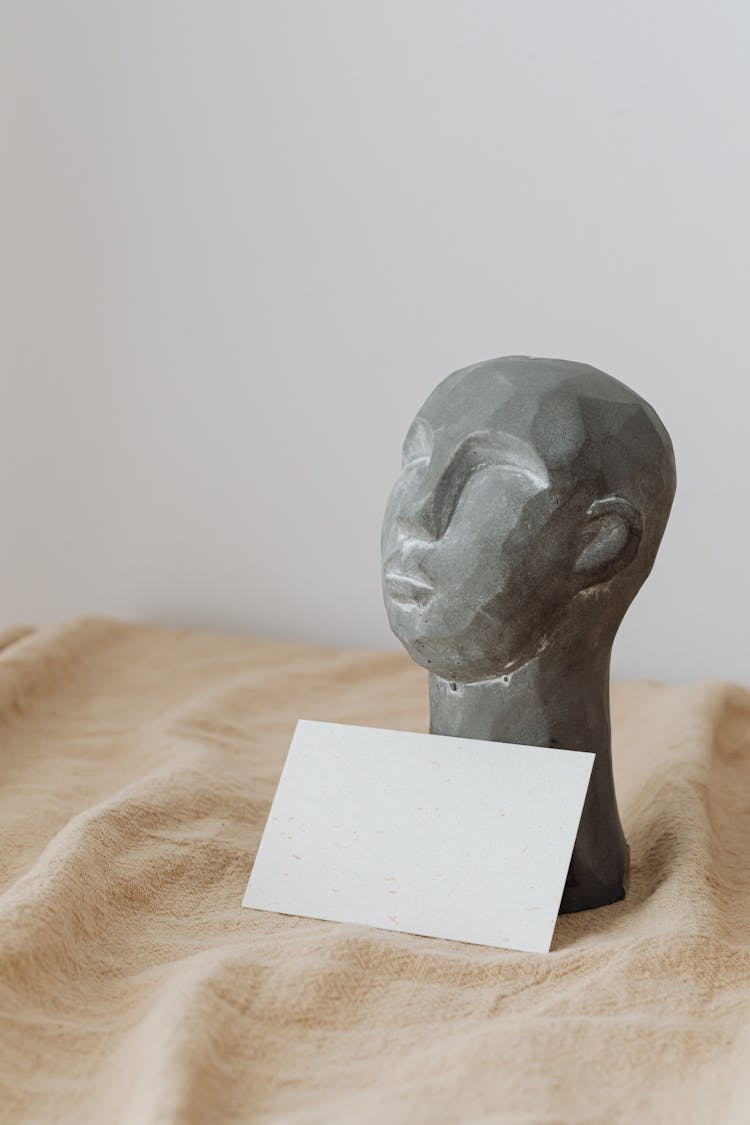 Head Figurine And Paper Sheet