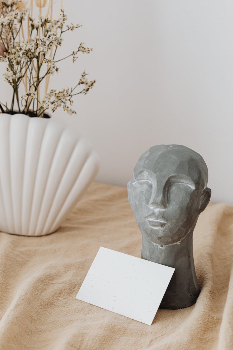 Stone Sculpture Of Head On Table