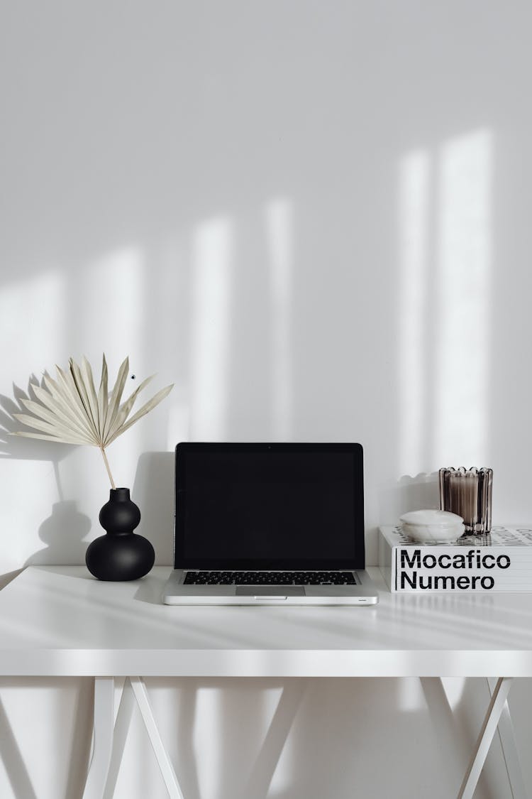 Laptop, Book And Flower On Table