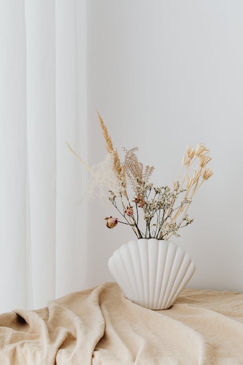 Beige Still Life with Dry Plants in Shell Shape Vase