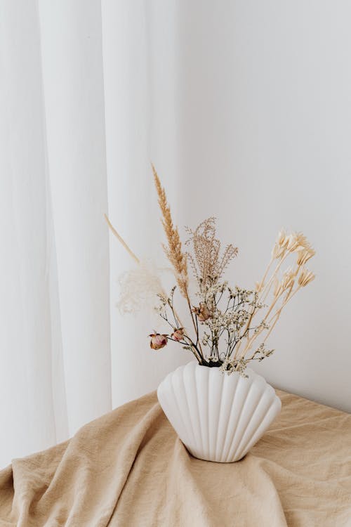 Dried Flowers in White Ceramic Vase