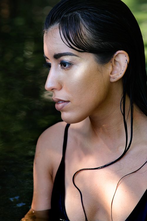 Free Close-up side view portrait of a thoughtful woman immersed in water, capturing serene and reflective mood. Stock Photo