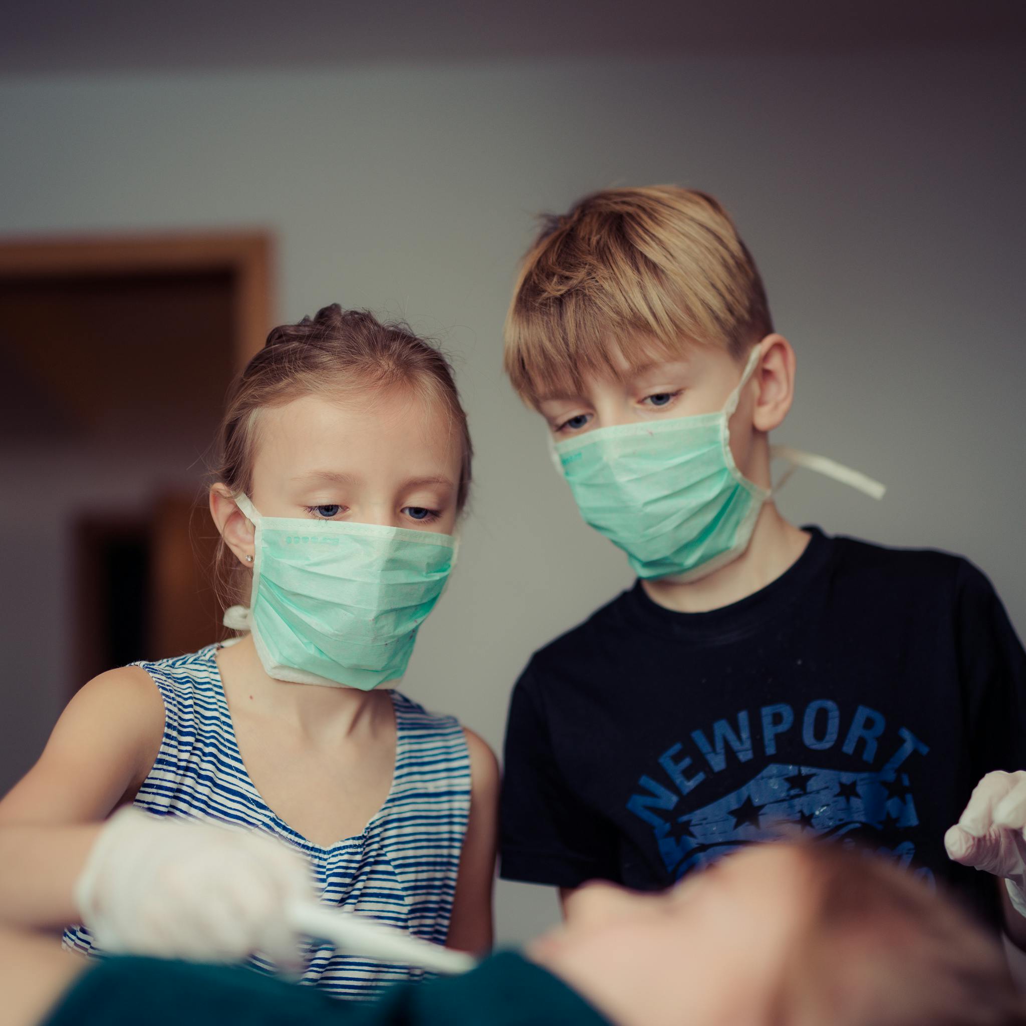 two children wearing surgical masks