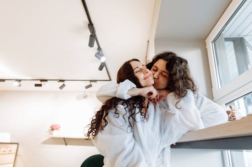 Happy couple shares intimate moment in cozy indoor setting, exuding warmth and closeness.
