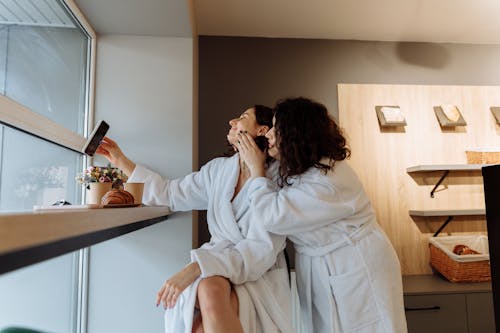 Woman in White Robe Drinking from a Glass