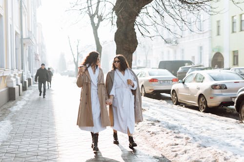 2 Women Walking on Snow Covered Road