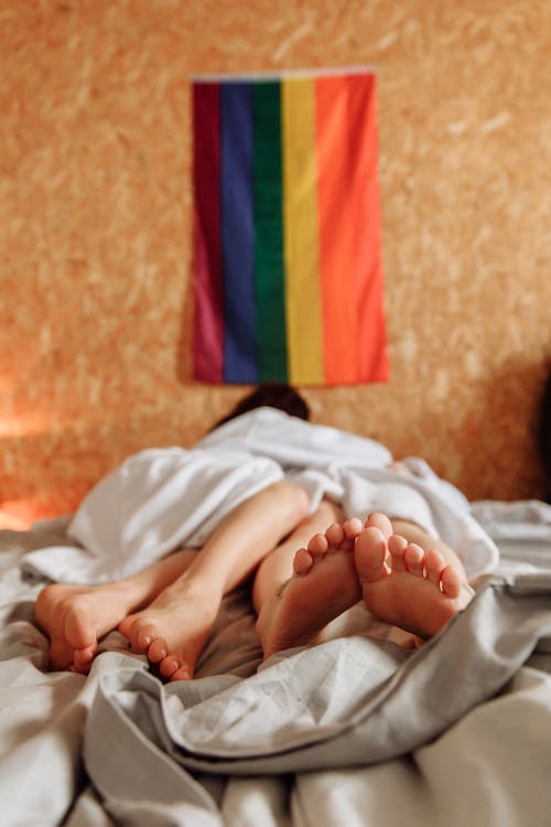 Free A Couple Lying Down on the Bed  Stock Photo