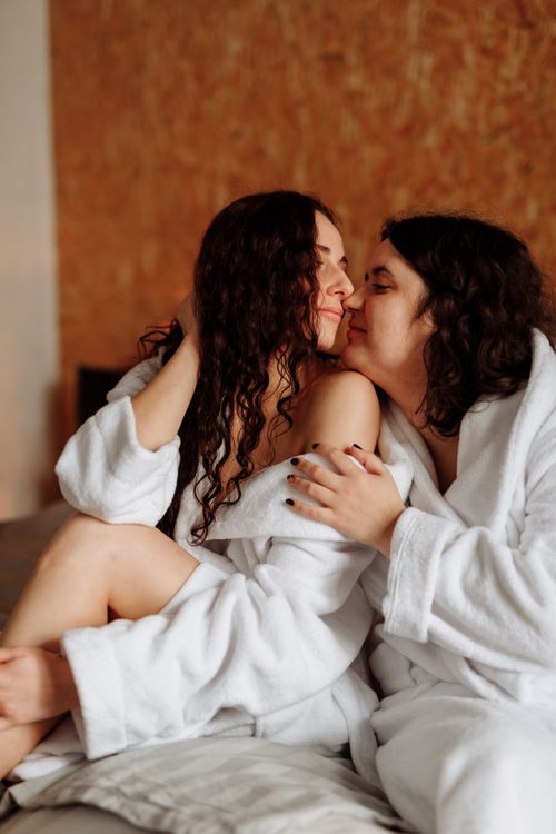 Free Intimate moment between two women in bathrobes, highlighting love and togetherness. Stock Photo