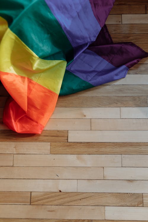 Rainbow Flag on Wooden Floor