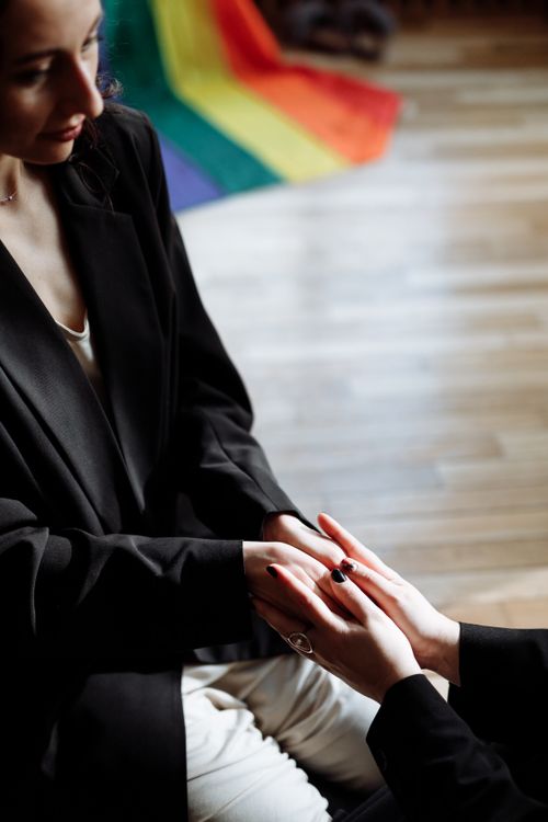 Free Close-up of a loving LGBTQ+ couple holding hands, symbolizing love and unity. Stock Photo