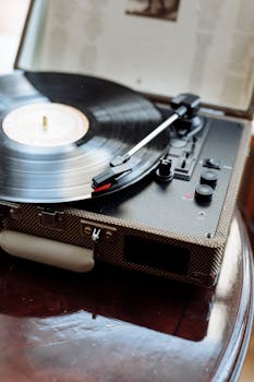 A close-up of a vintage turntable with a spinning vinyl record, evoking nostalgia and classic music vibes.