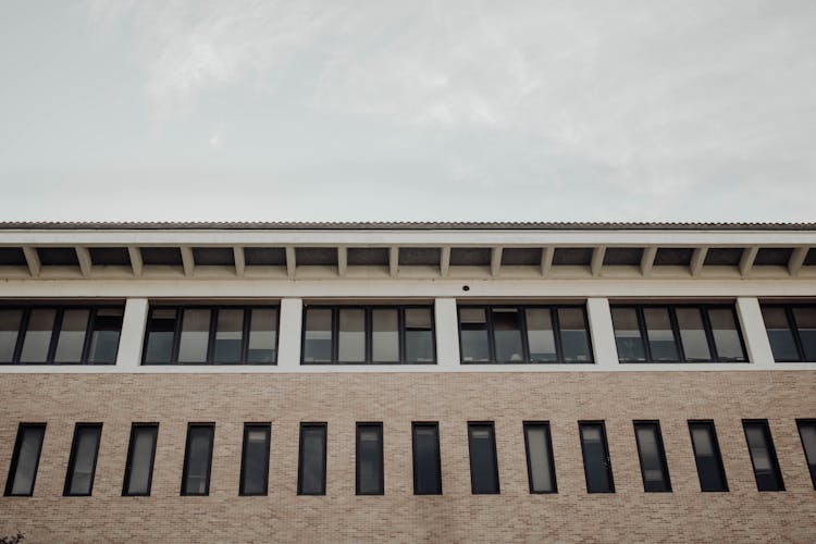 Facade Of A Long Building With Windows 