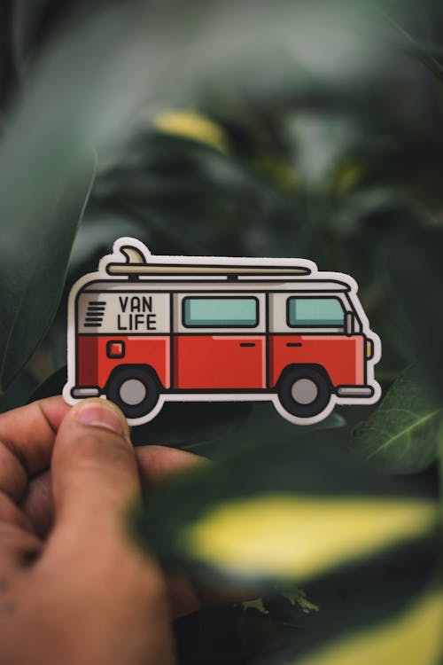 Free Close-Up Shot of a Person Holding a Van Sticker Stock Photo