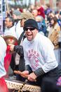 Man in White Crew Neck Long Sleeve Shirt and Black Knit Cap Sitting on the Street
