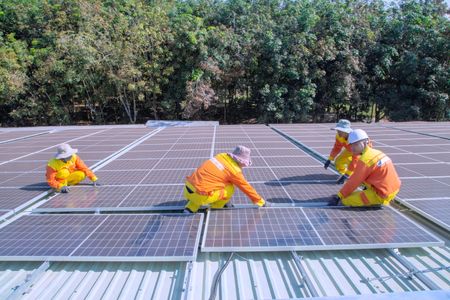 Team of workers installing solar panels