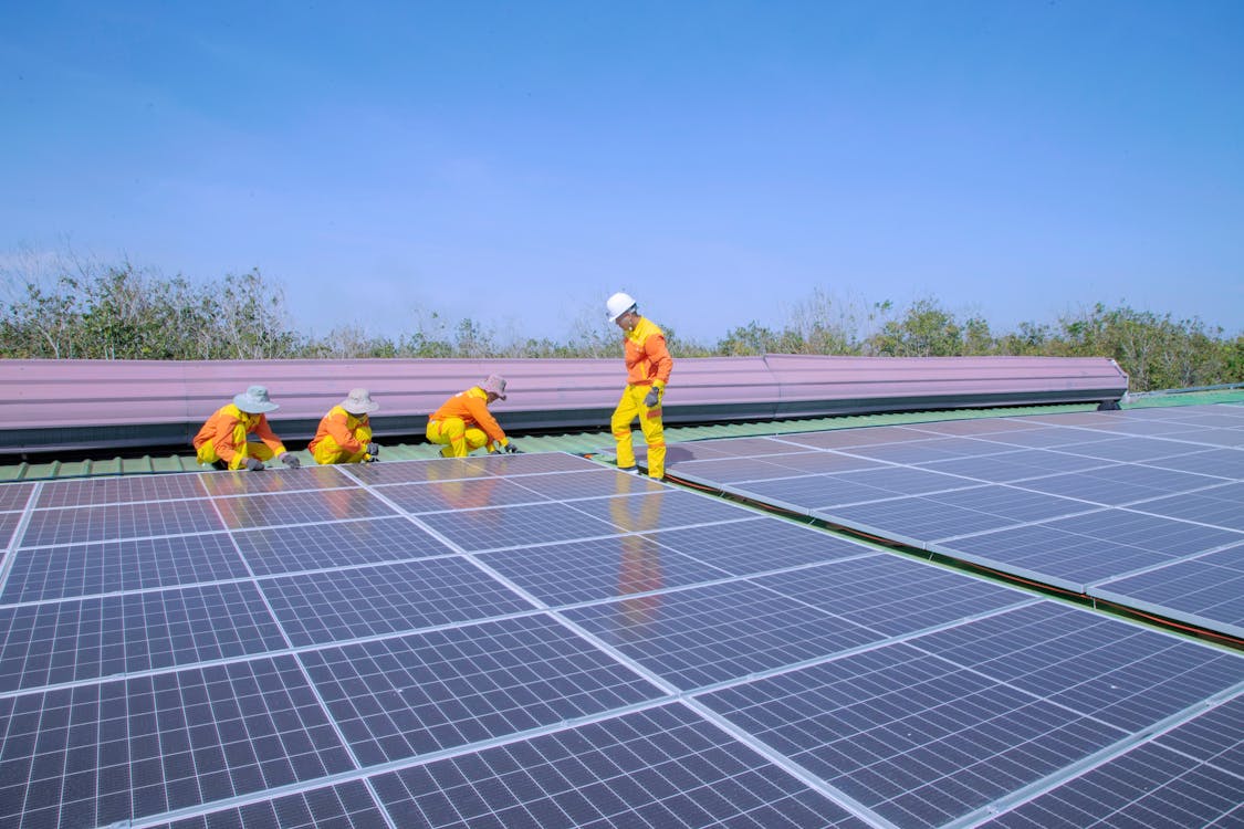 Free Solar Technicians Installing Solar Panels Stock Photo