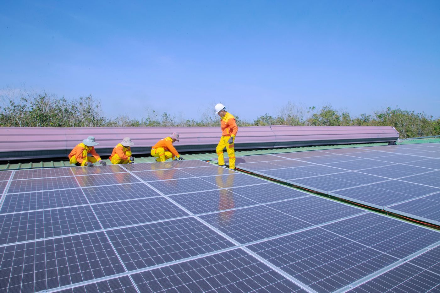 Fotografía ilustrativa de técnicos instalando paneles solares