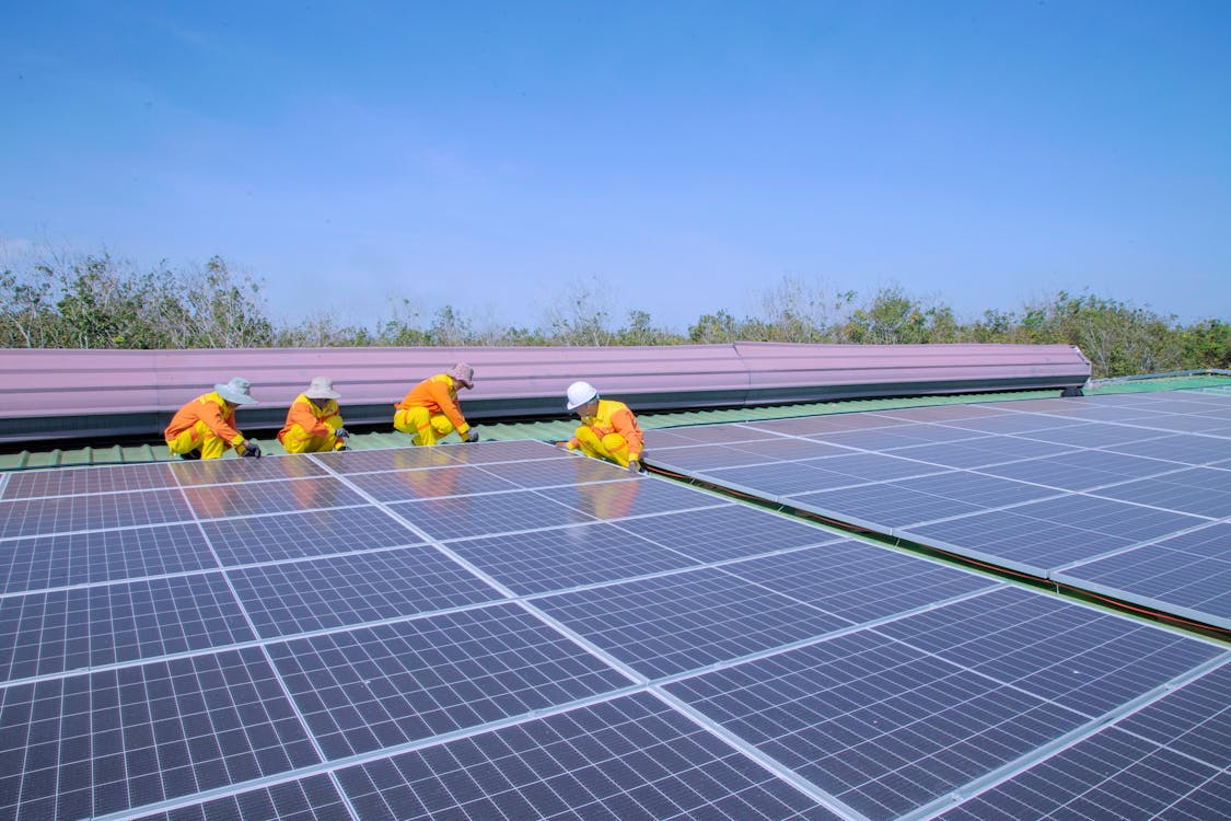 Free Solar Technicians Installing Solar Panels Stock Photo