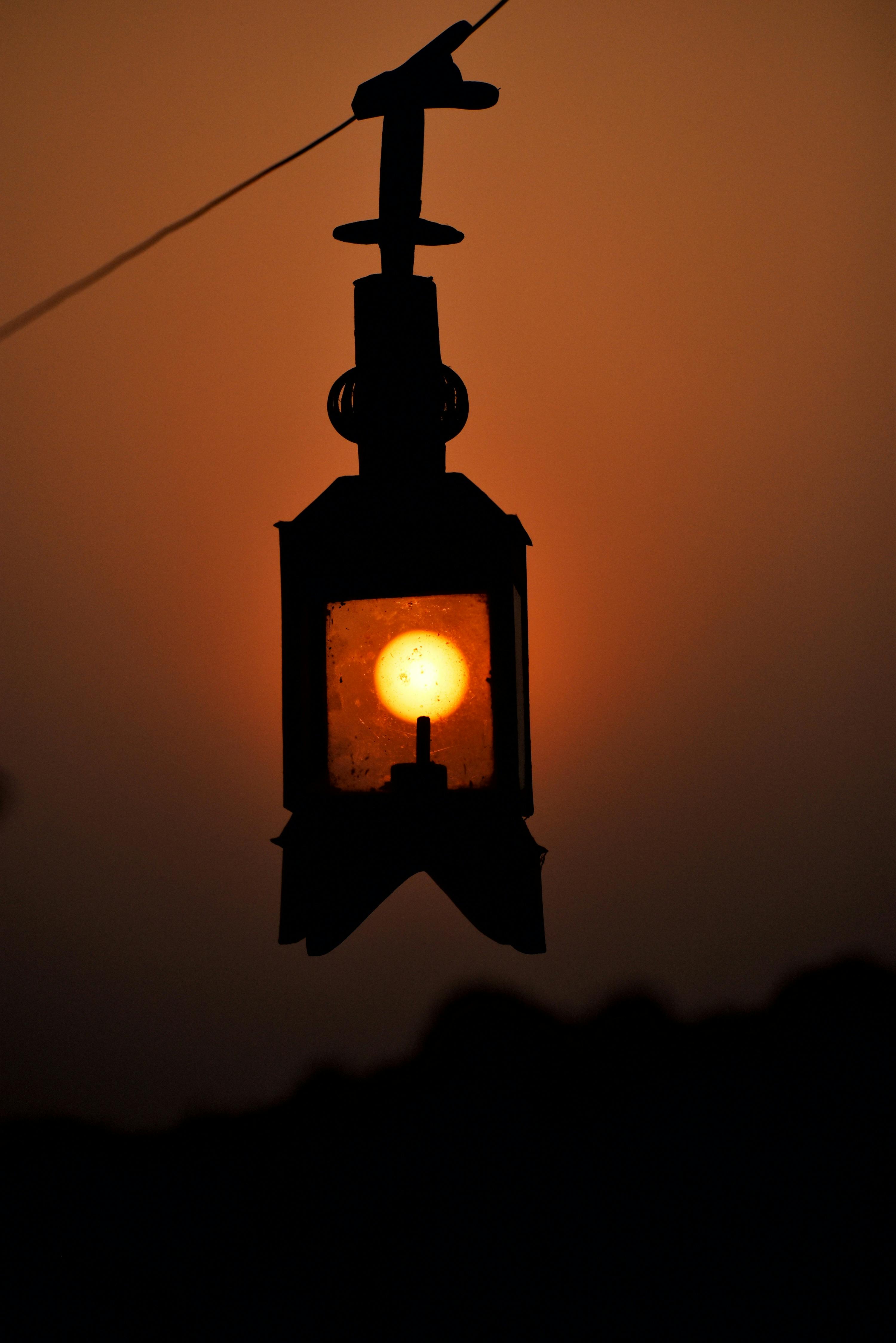 a hanging street lamp under evening sky