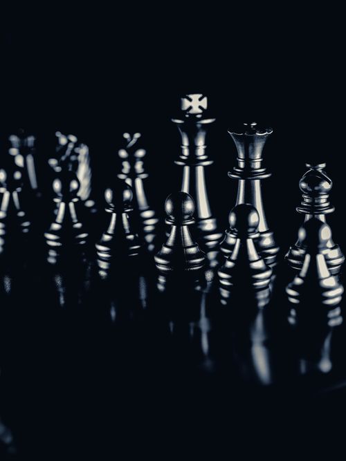 Free Artistic close-up of monochrome chess pieces on a reflective surface. Stock Photo