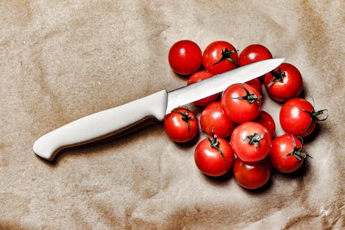 Free Tomatoes With Knife on Brown Surface Stock Photo