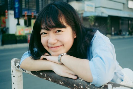 Cheerful young woman smiling outdoors in Chiang Mai, Thailand. Bright and joyful portrait.