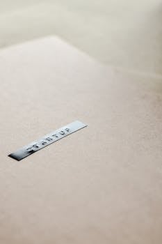 Close-up of a startup label on a minimalist brown background, emphasizing entrepreneurship.
