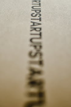 Blurred focus on the word 'Startup' on a textured paper surface.