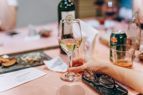 Person Holding Clear Wine Glass with Wine