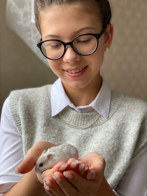 Smiling Woman Looking at a Hamster