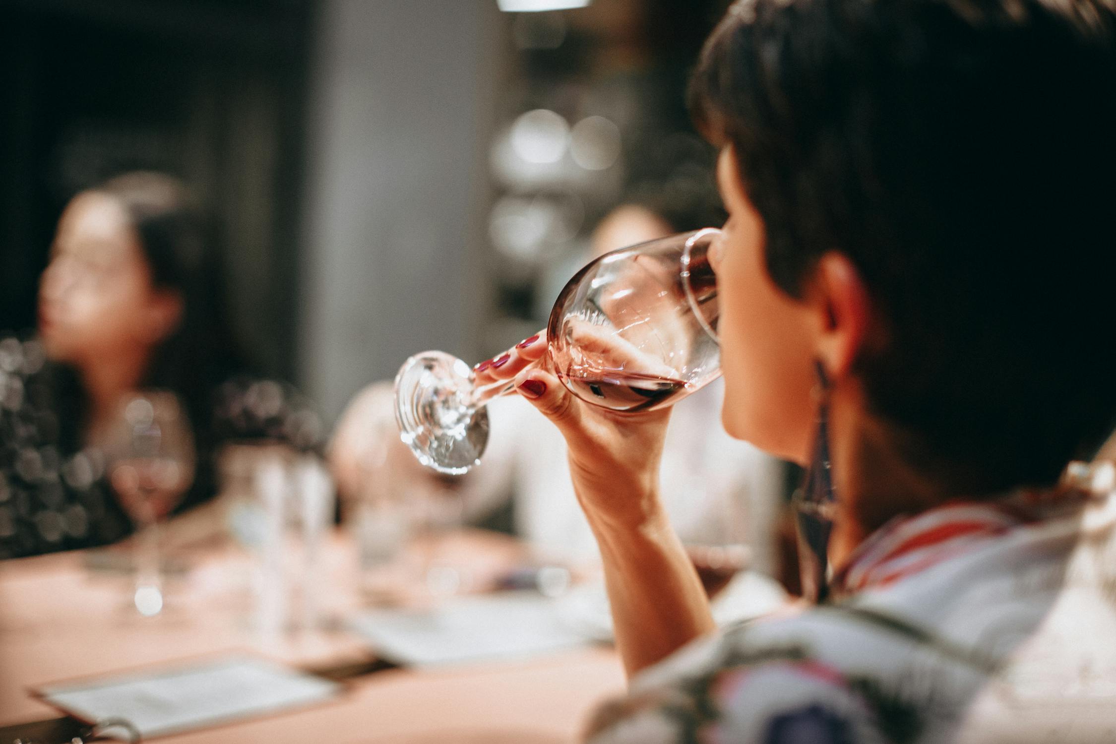 A woman drinking a glass of wine