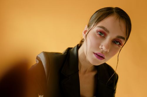 Free Close-up portrait of a woman in a studio with bold makeup and leather jacket. Stock Photo