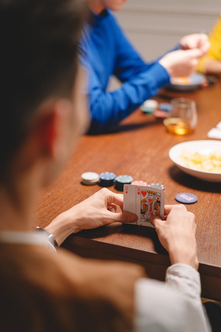 Photograph Of A Man Playing Poker