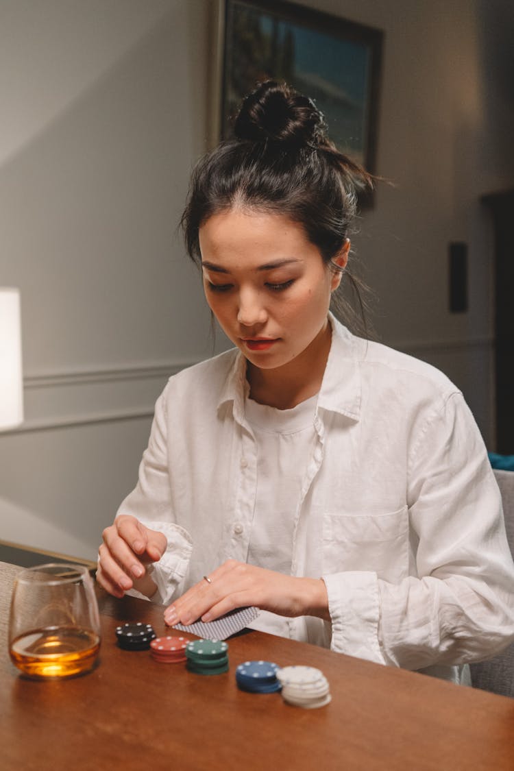 Woman In White Long Sleeves Holding Poker Cards