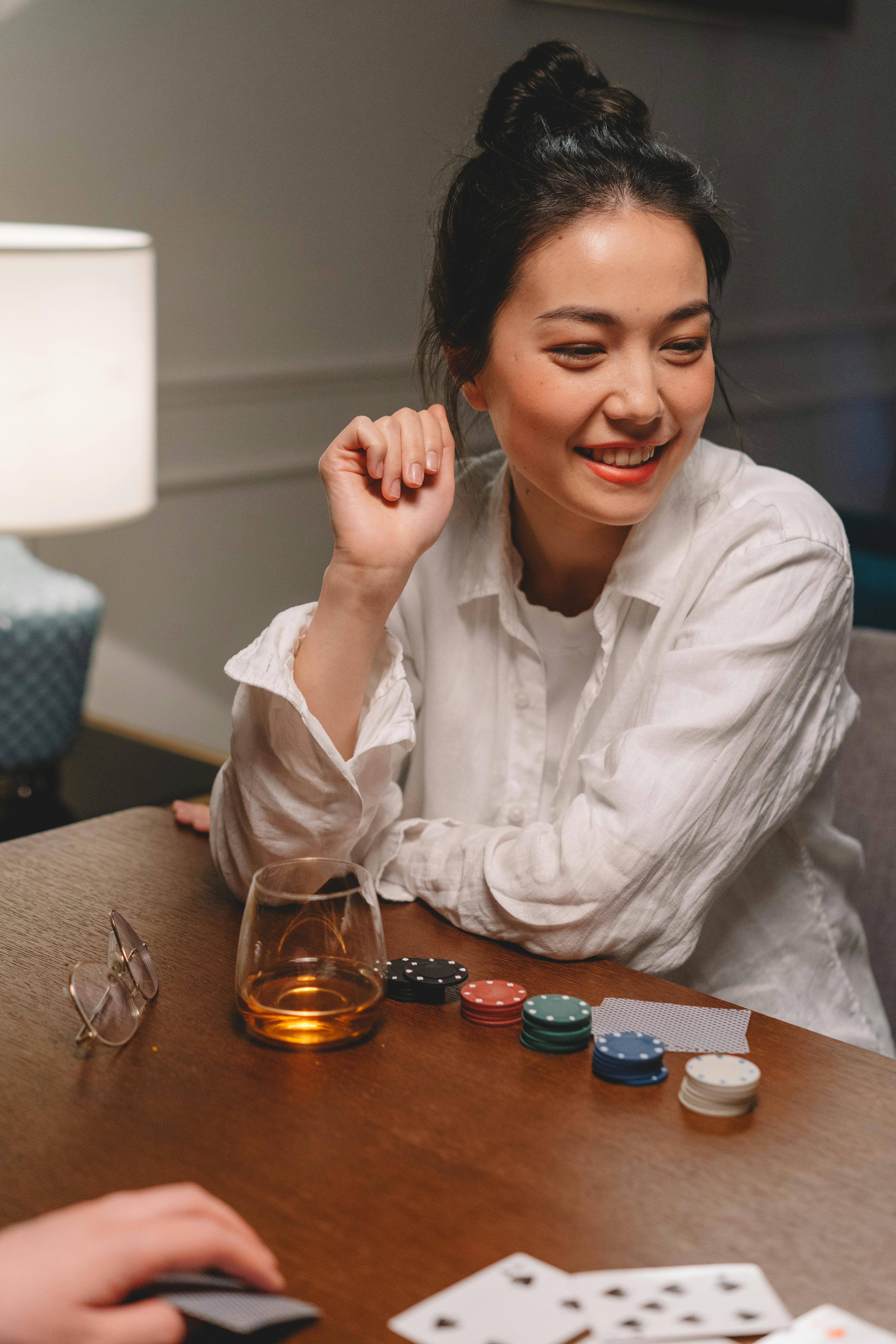 woman playing poker on the wooden table