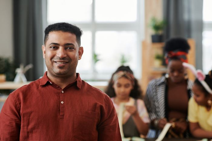 Educator surrounded by children in a child care centre