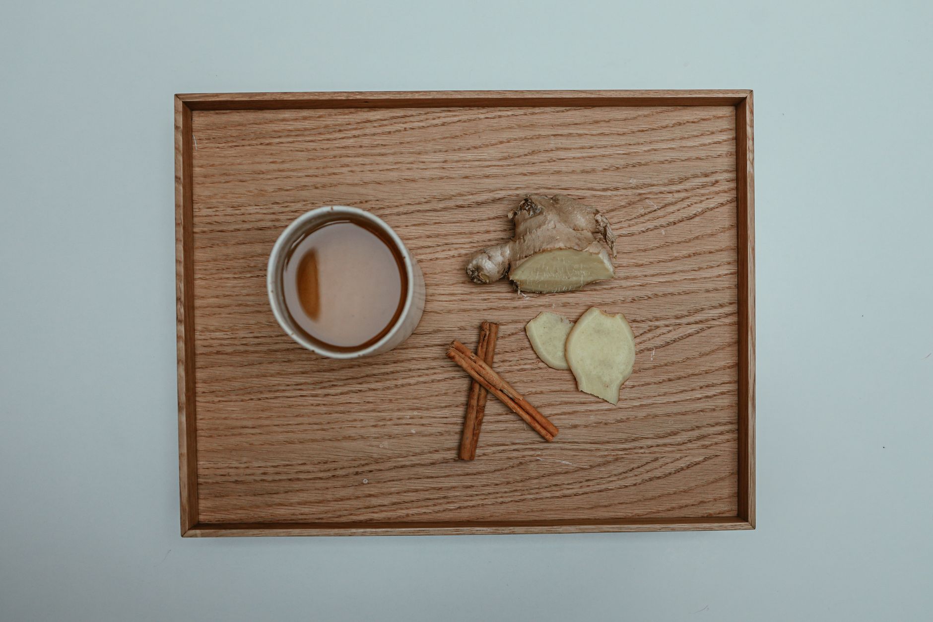 Refreshing spicy ginger ale cocktail on a wooden table