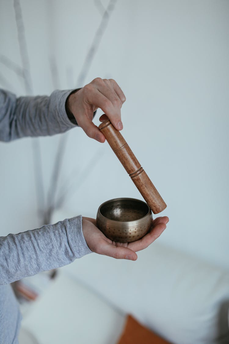 Person Holding A Wooden Mallet