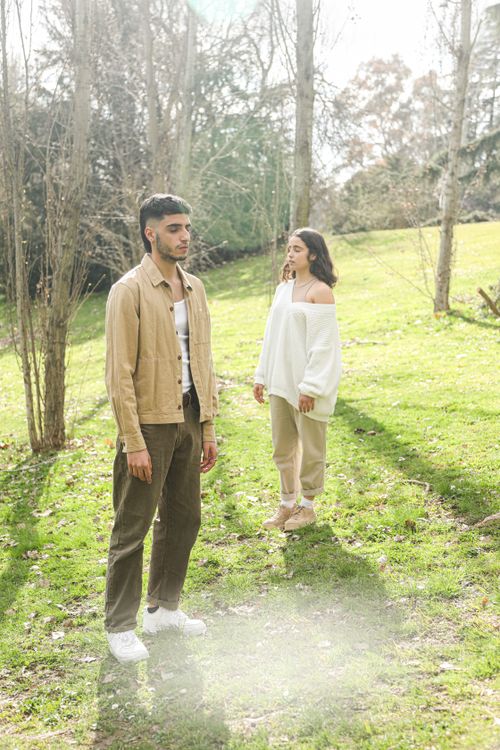 Free Young man and woman enjoying a peaceful moment in a serene outdoor setting. Stock Photo