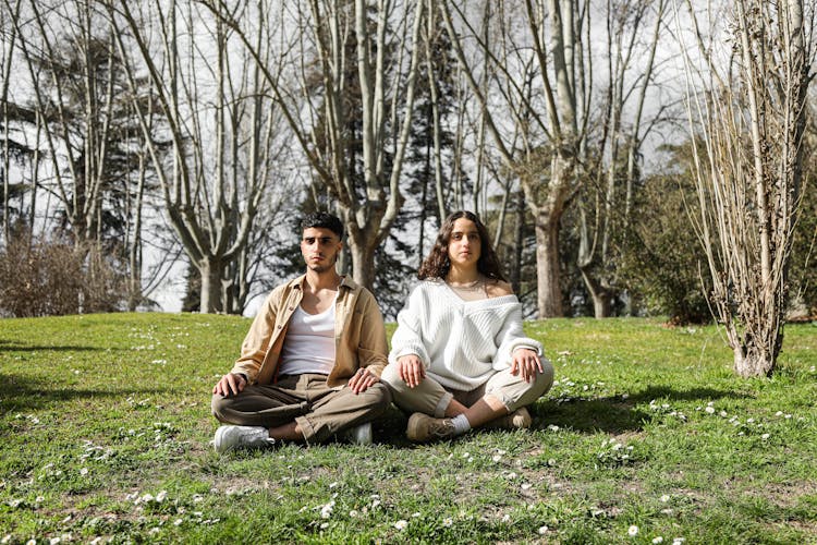 A Couple Sitting On The Ground