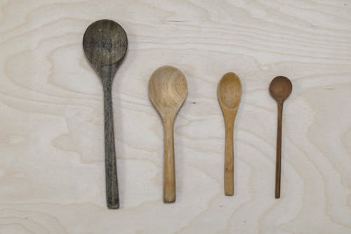 Free Spoons and Spatulas on a Wooden Surface Stock Photo
