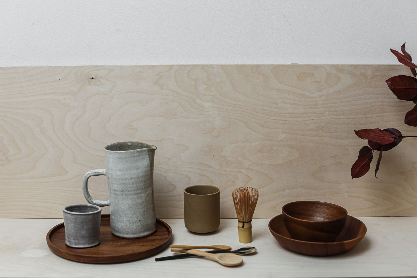A rustic still life featuring pottery and wooden kitchen utensils, perfect for decor inspiration.