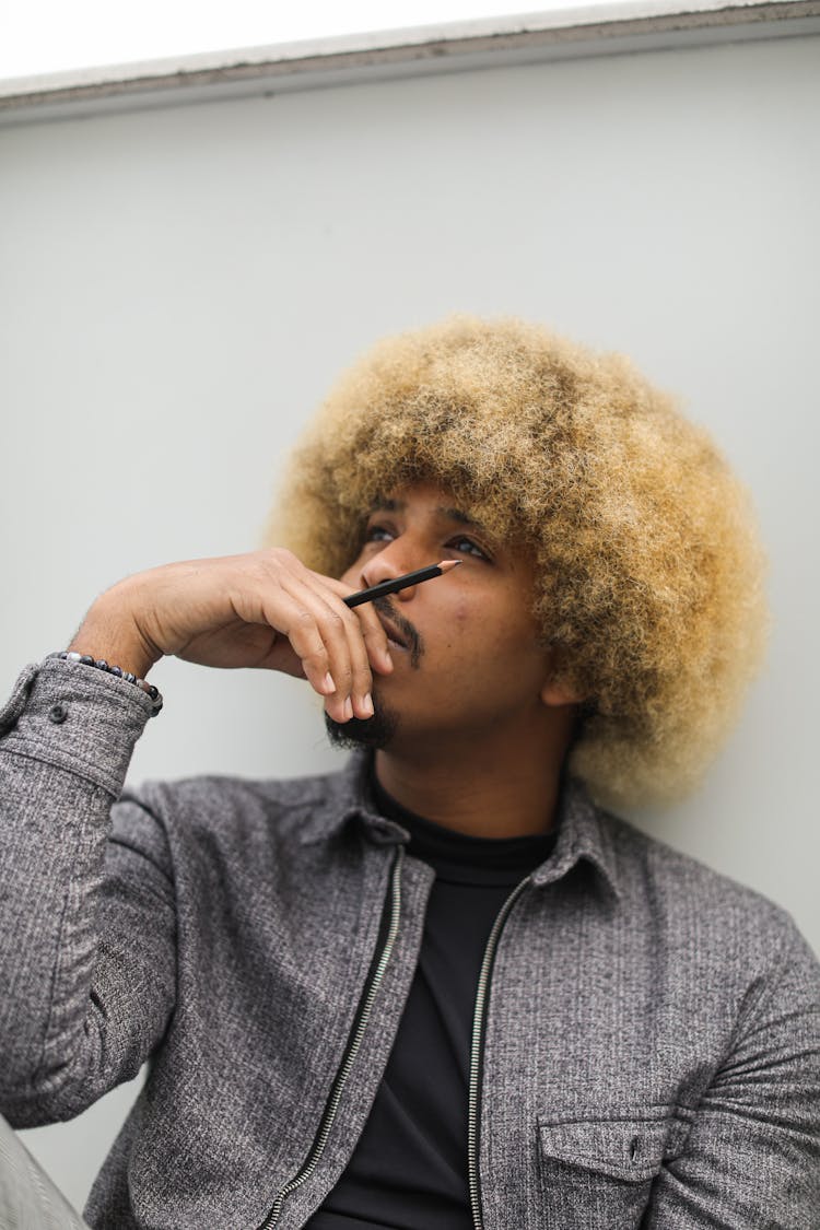 Man With Beard And Blonde Afro Hairstyle In Deep Thoughts