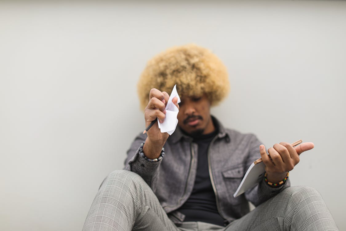 Free Man Sitting on Floor Having Deep Thoughts on what to Write : How to Crack Scholarship Interviews for US Students