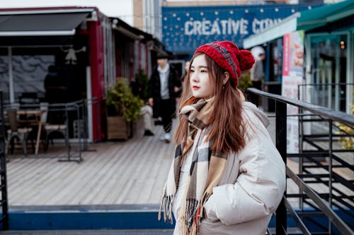 Selective Focus Photo of a Beautiful Woman Posing with Her Hand in Her Pocket