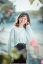 Selective Focus Photo of a Woman in a White Long Sleeve Shirt Smiling