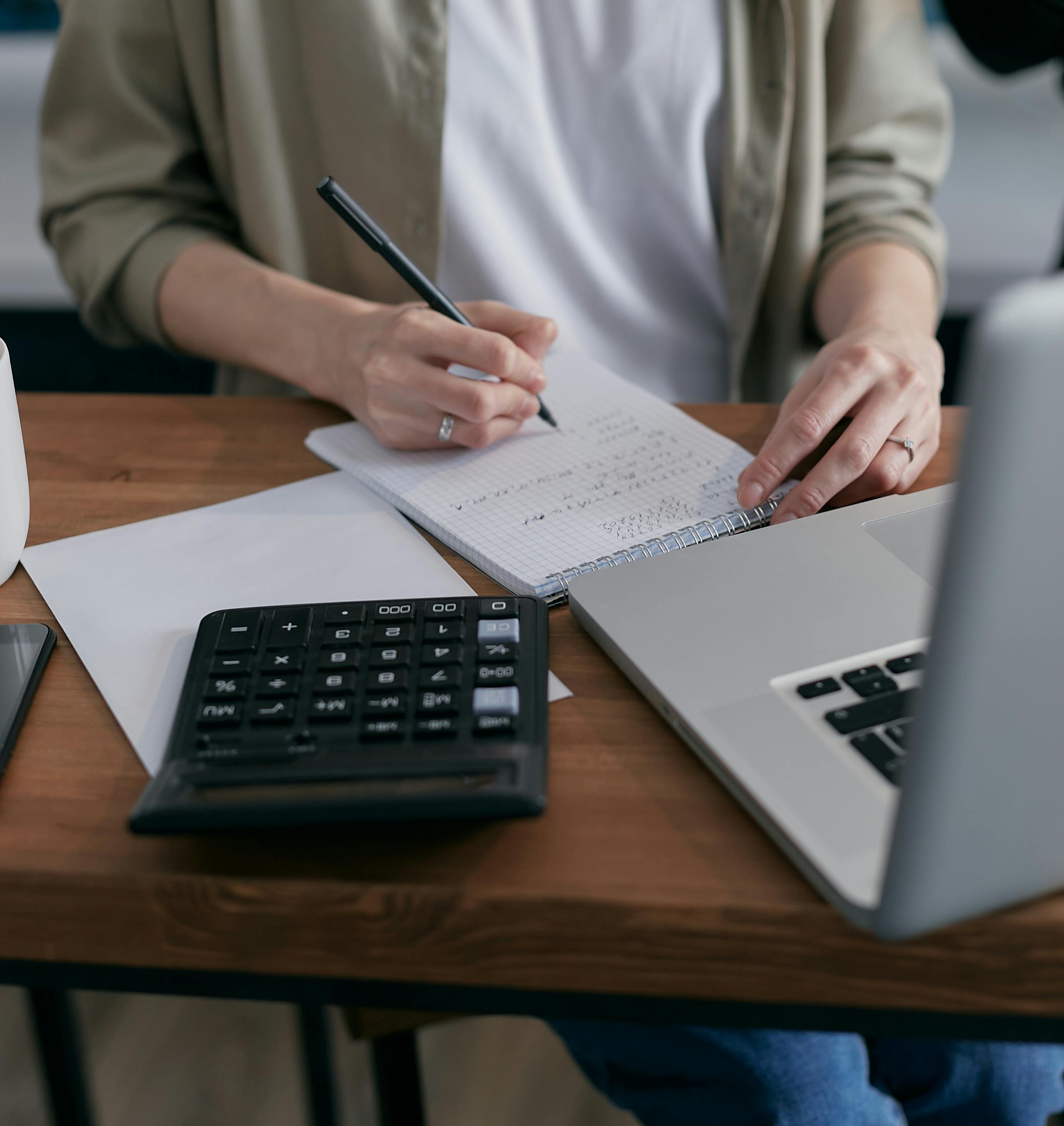 person calculating on a notebook