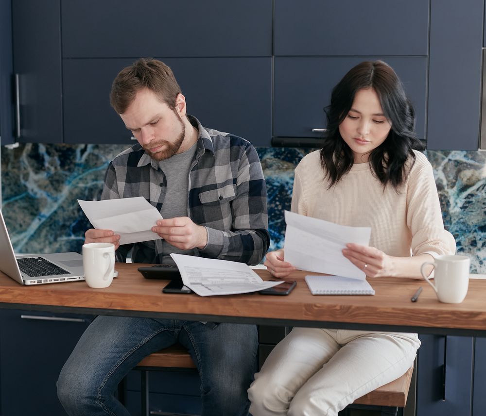 Family reviewing financial bills and paperwork together