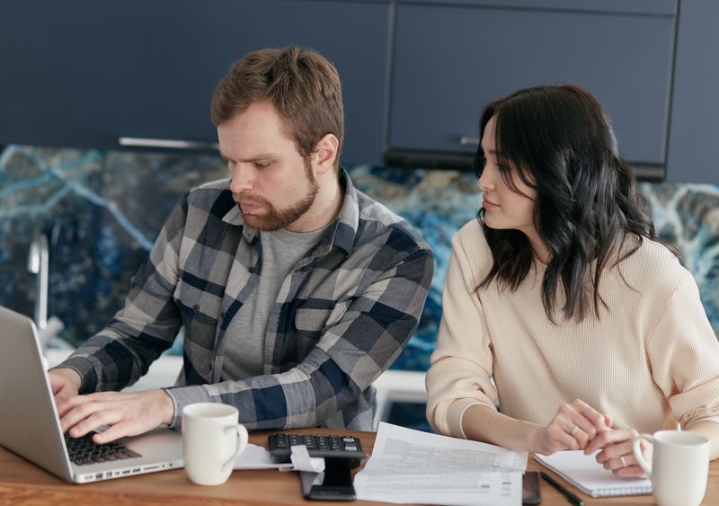A couple reviewing their finances together at home